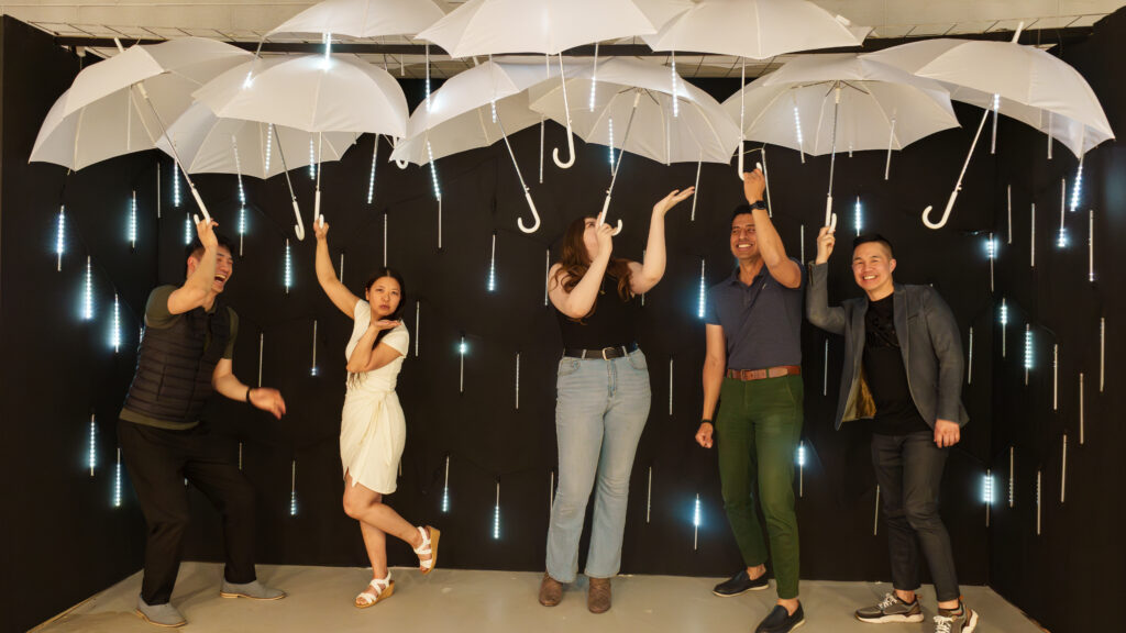 A vibrant and colorful photo booth setup at the Calgary Selfie Museum, featuring dynamic lighting and interactive elements