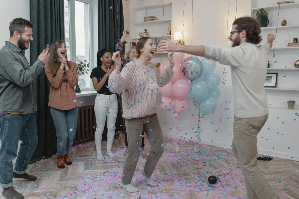 People smiling and celebrating at a beautifully decorated baby shower