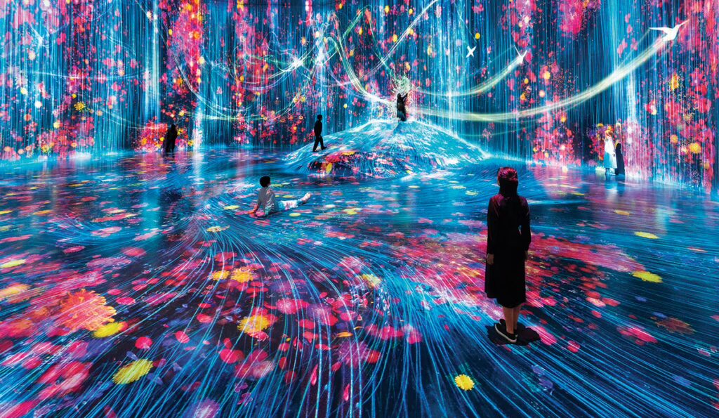 Visitors immersed in a dynamic light and projection environment at teamLab Borderless in Tokyo