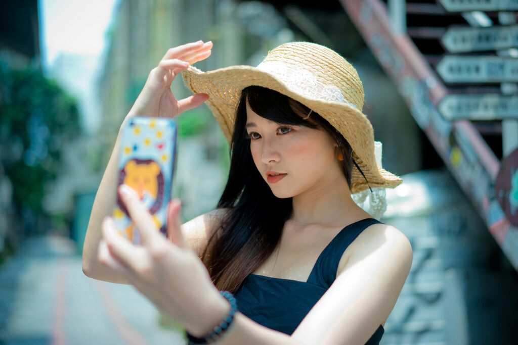woman wearing brown summer hat enjoying sunny Calgary park photo spot