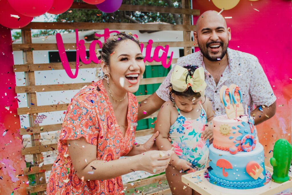 Birthday party ideas Calgary, family celebrating a birthday with cake and balloons