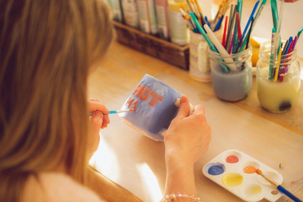 Birthday party ideas Calgary, person painting on a mug at creative art studio birthday party