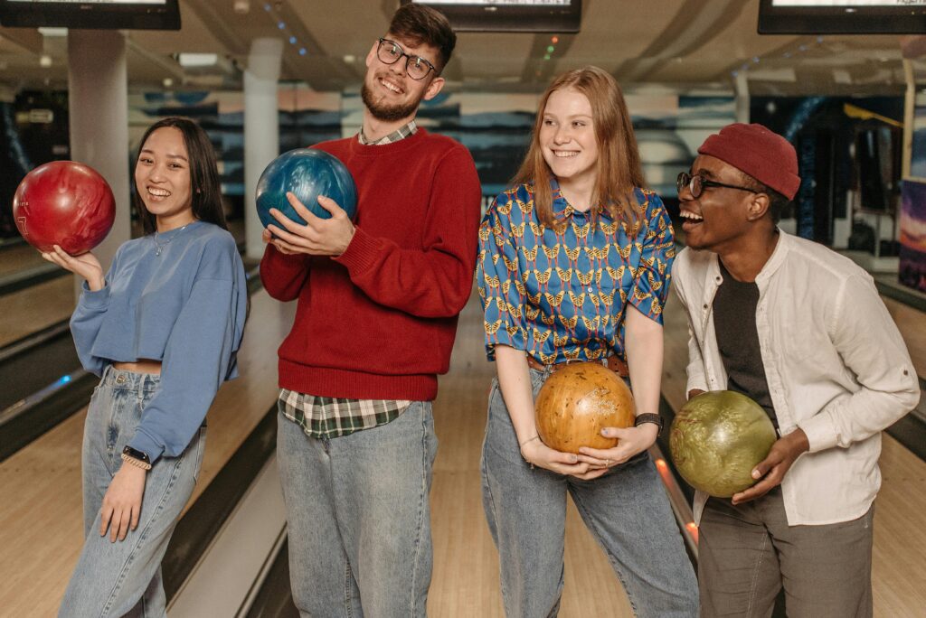 four people posing with bowling ball -Calgary corporate team activity