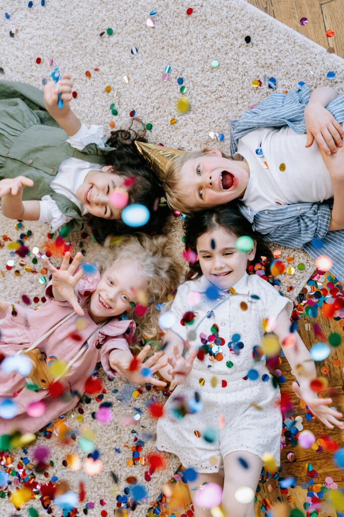Kids celebrating a birthday with colorful confetti, a joyful example of fun kids birthday party ideas in Calgary Photo by Ivan Samkov